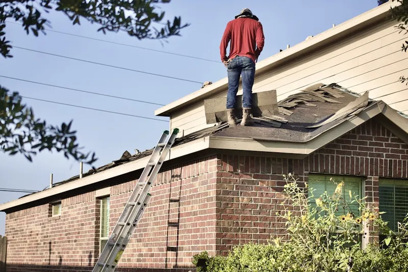 Professional roofer working on a residential roof in Lake Norman of Iredell